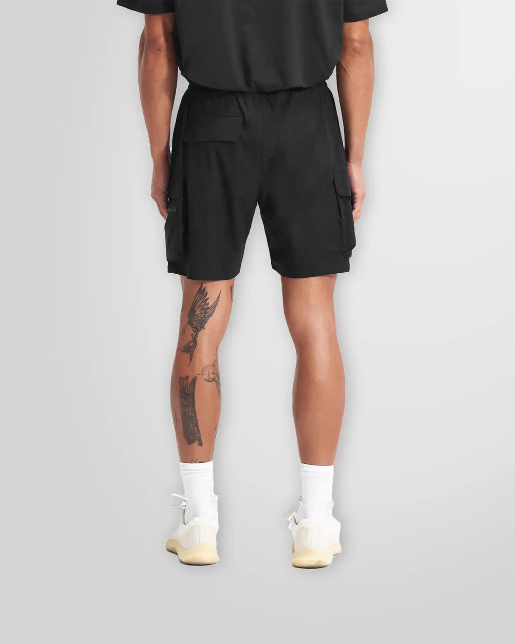 Side profile of the Represent 247 shorts in black, highlighting the functional cargo pocket.