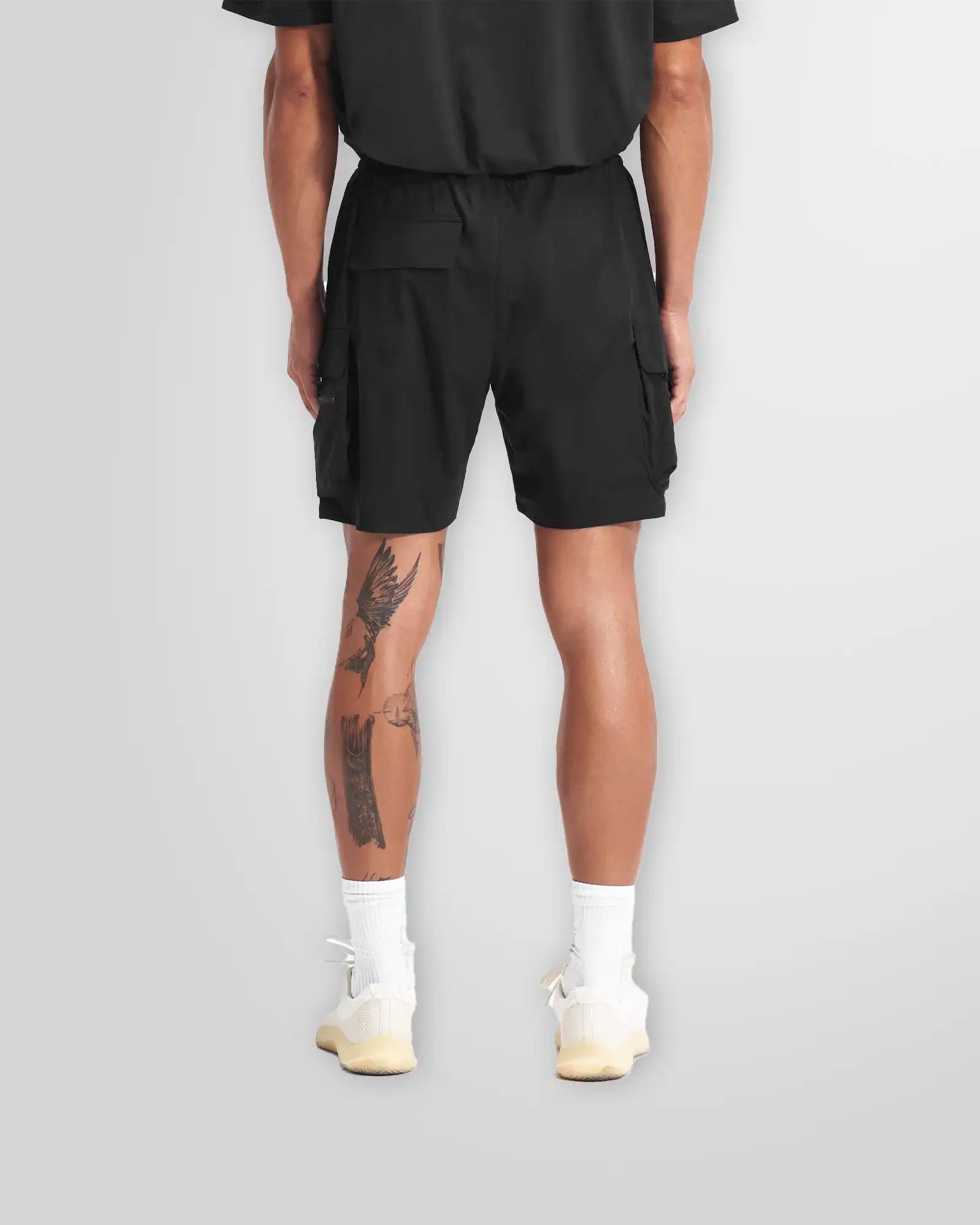 Side profile of the Represent 247 shorts in black, highlighting the functional cargo pocket.