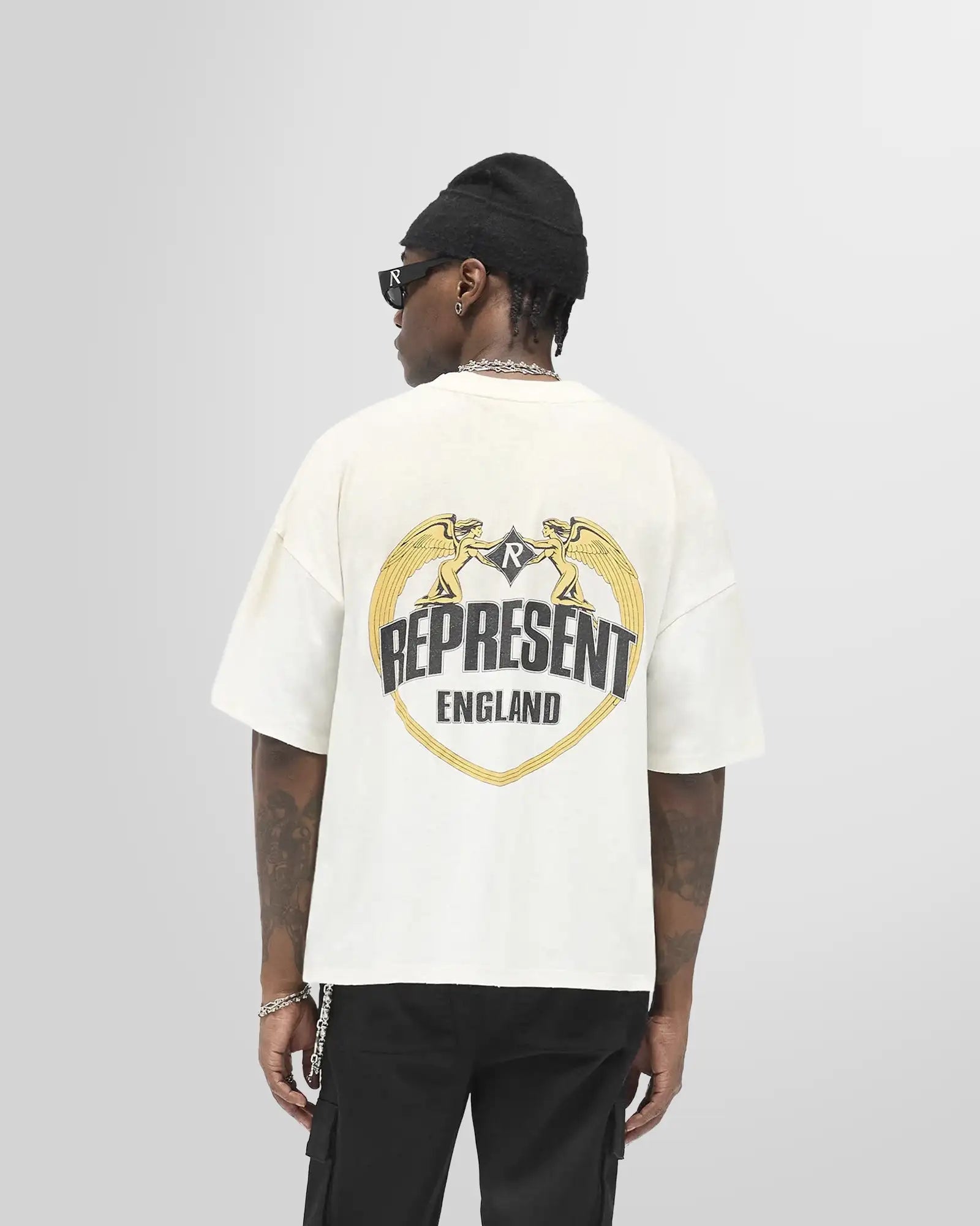 Back view of a model wearing the Angel Border cracked print on Washed Ecru and boxy fit.