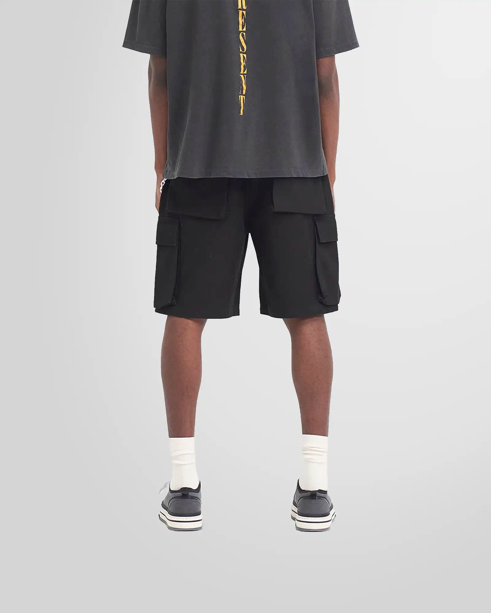 Model wearing the Represent Baggy Cargo Shorts to demonstrate the modern, oversized silhouette.