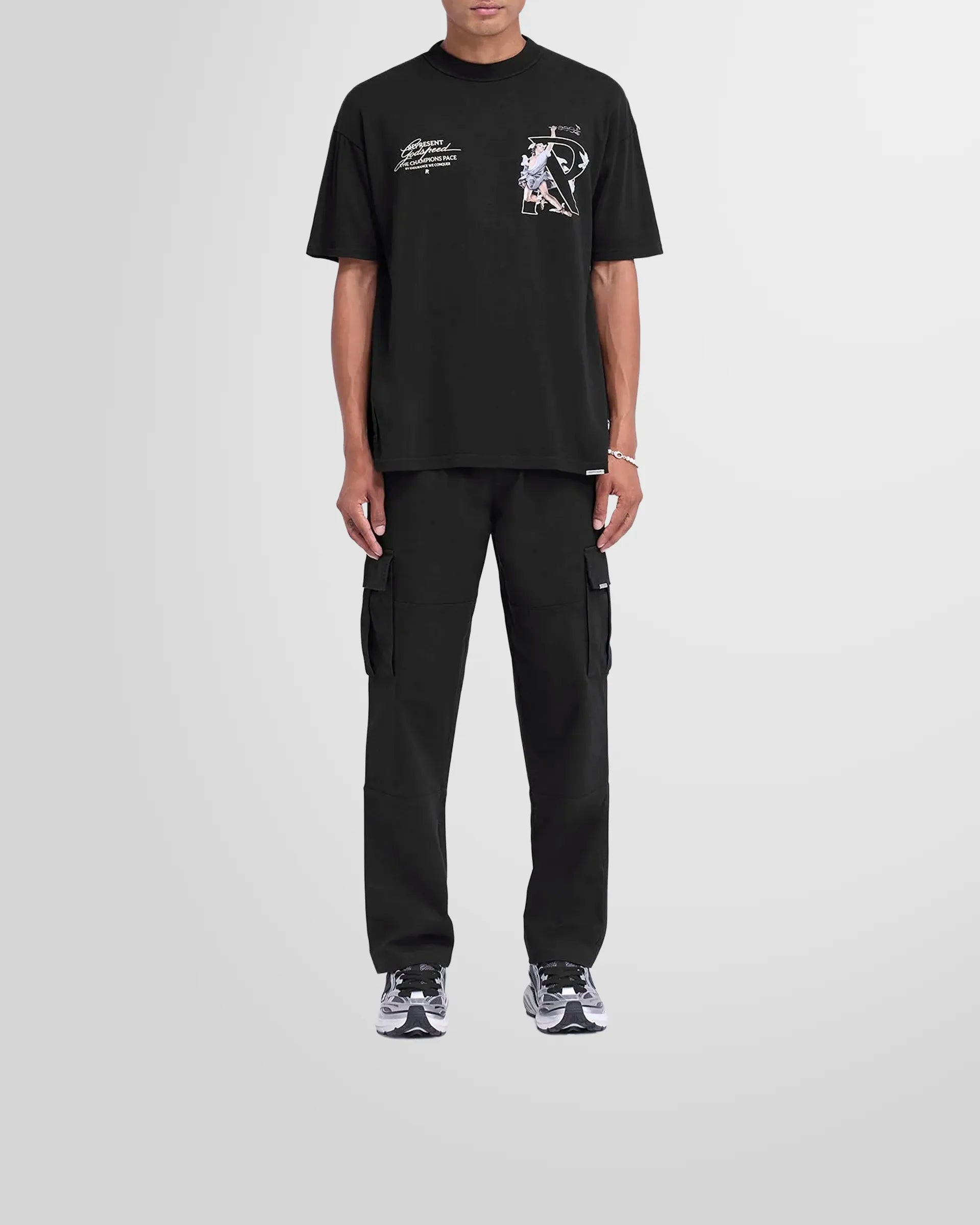Front view of the Represent Cargo Pant in black on a model.