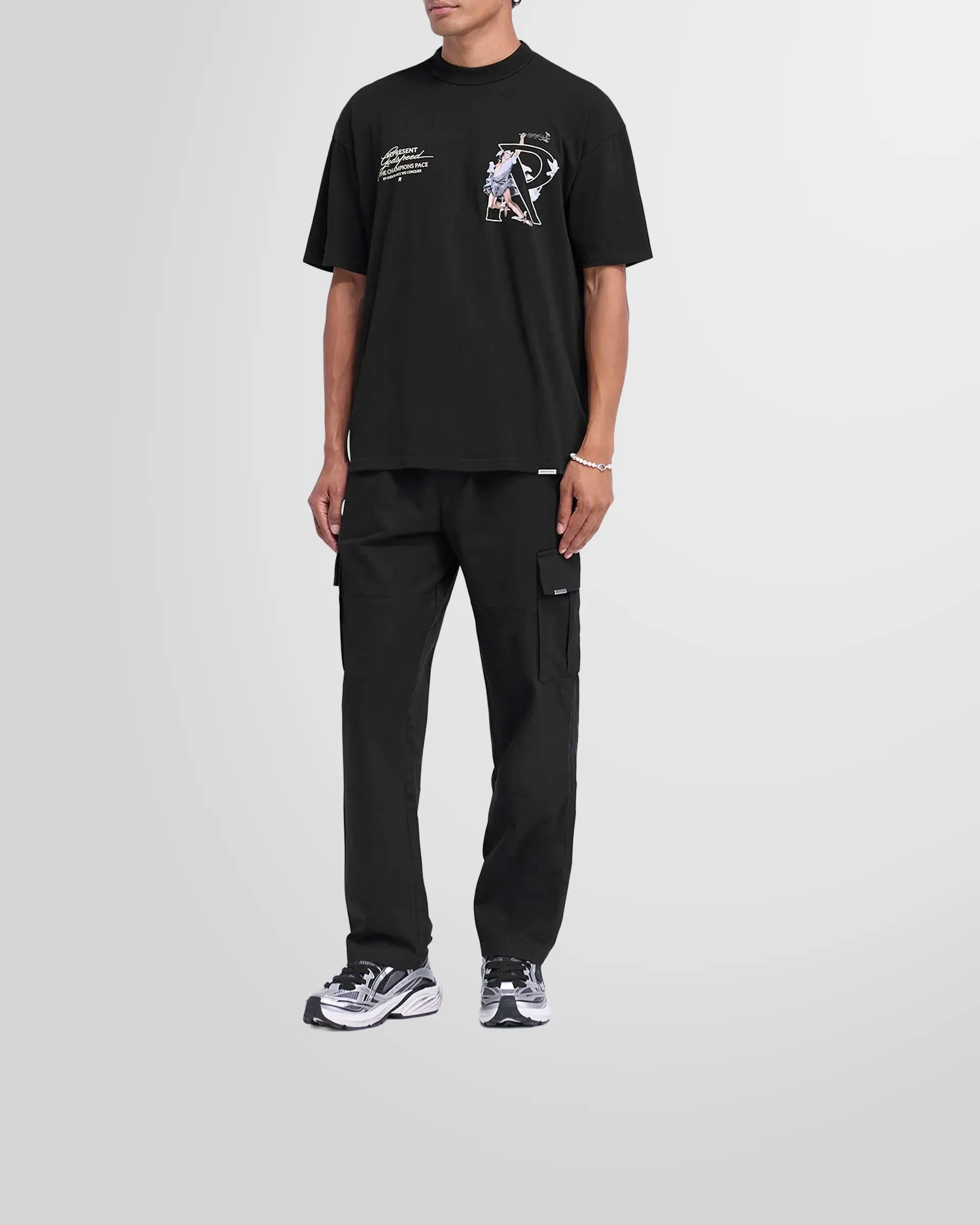 Model wearing the Represent Cargo Pant in black, showcasing its everyday essential style.