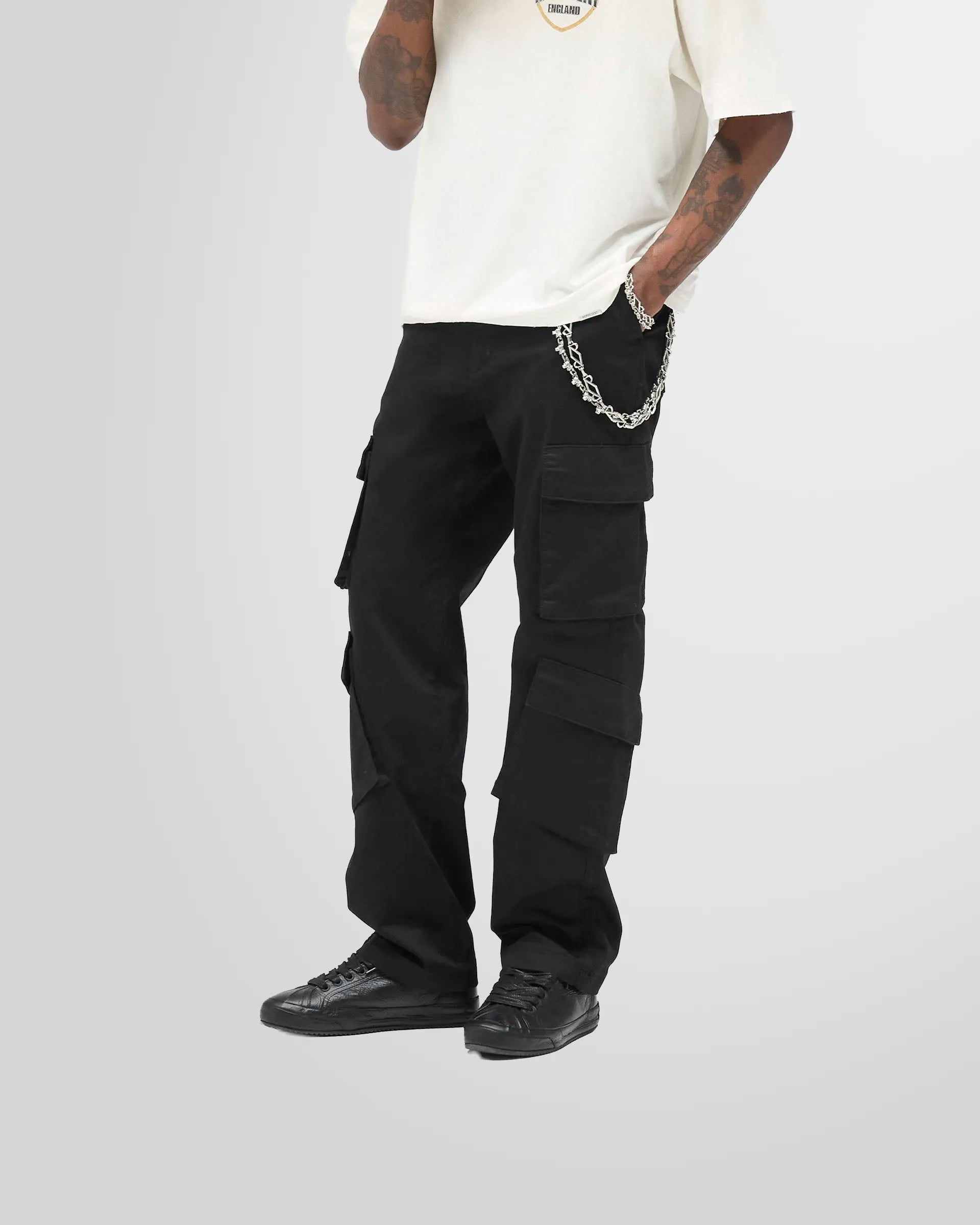 The Represent Cargo Pant in jet black, showed from the side.