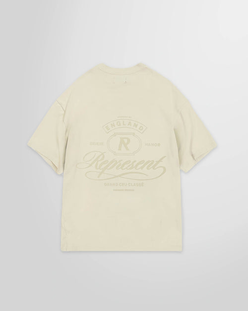Back view of the Represent Grand Vintage T-Shirt in Champagne with the rear tonal graphic.