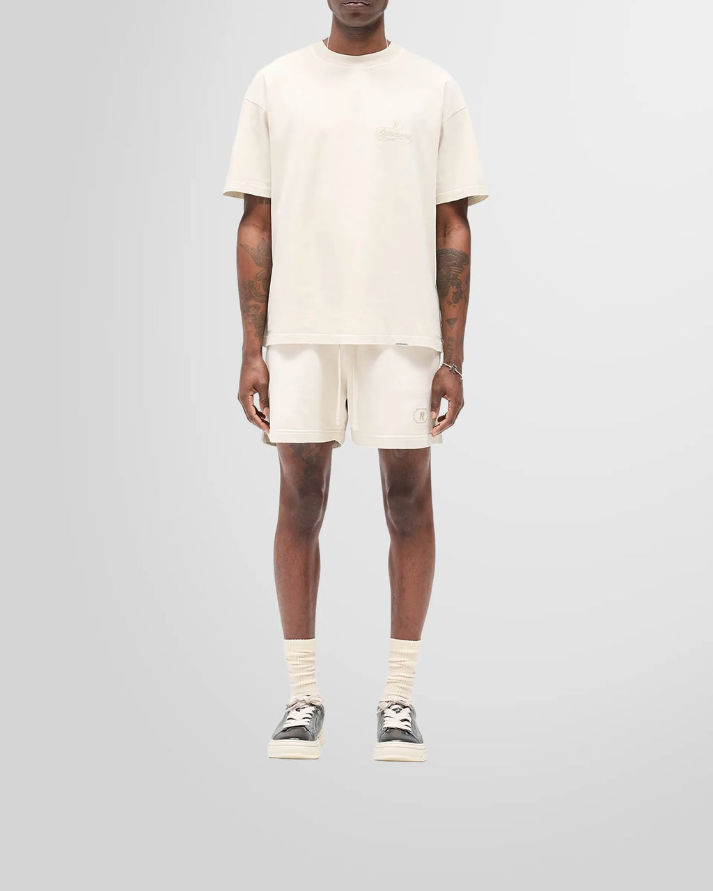 Model wearing the oversized Represent Grand Vintage T-Shirt in Champagne.