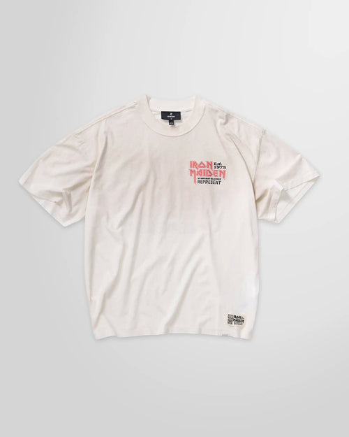 Front view of the Represent x Iron Maiden 50th Anniversary t-shirt in washed ecru, showing the main crack-print graphic.