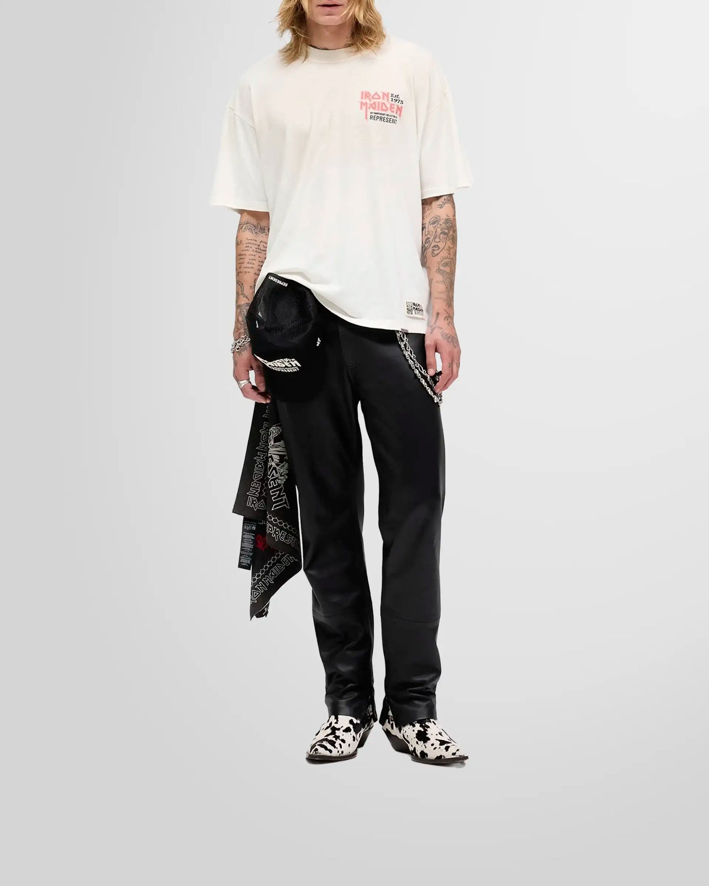 Model wearing the oversized Represent x Iron Maiden anniversary t-shirt in washed ecru, showcasing its shorter, boxy fit.