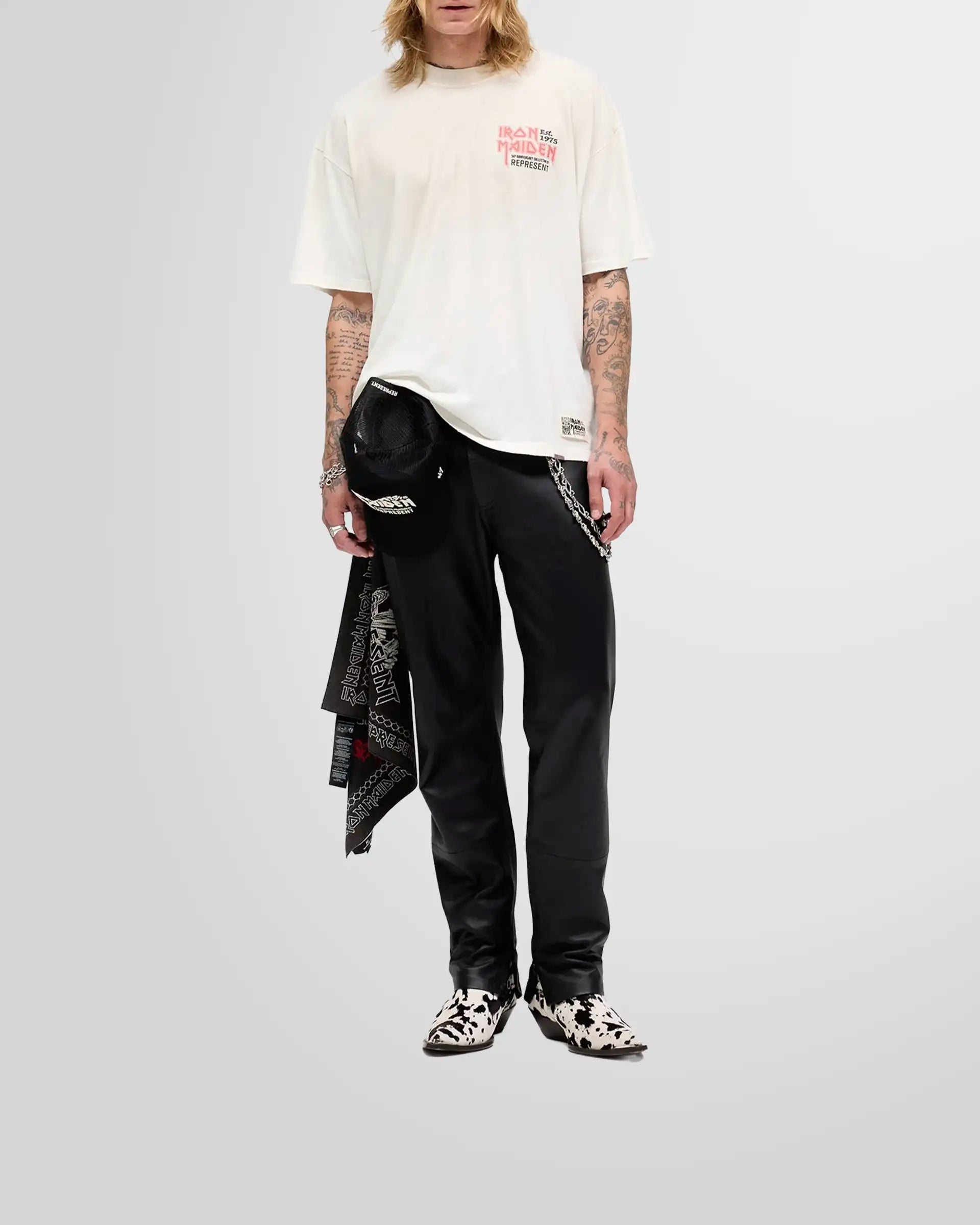 Model wearing the oversized Represent x Iron Maiden anniversary t-shirt in washed ecru, showcasing its shorter, boxy fit.