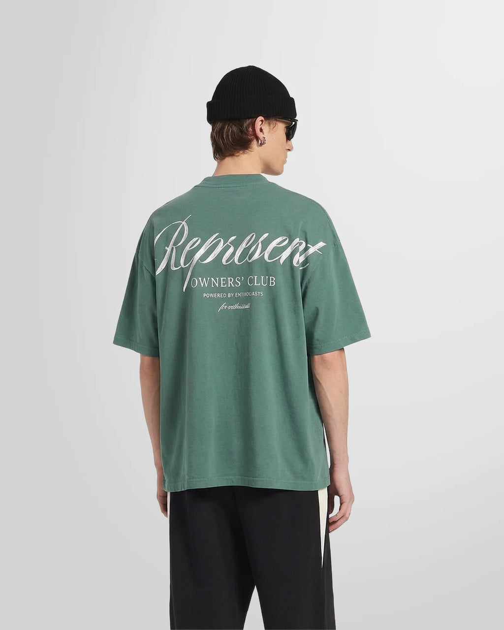 Back view of a model wearing the Owners’ Club script print with brushed effect in vintage green.