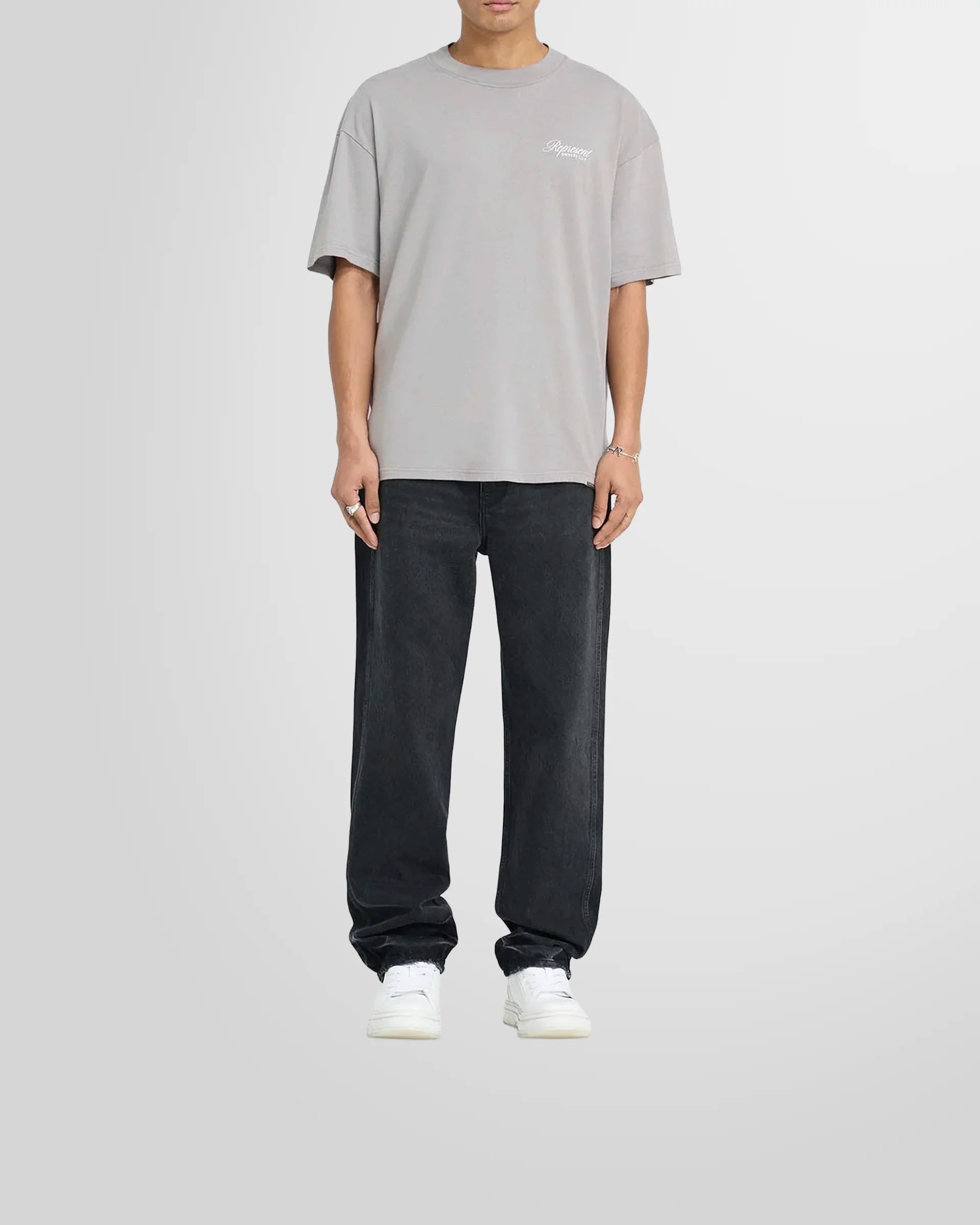 Model wearing the slightly oversized Represent Owners Club Script T-Shirt in slate.