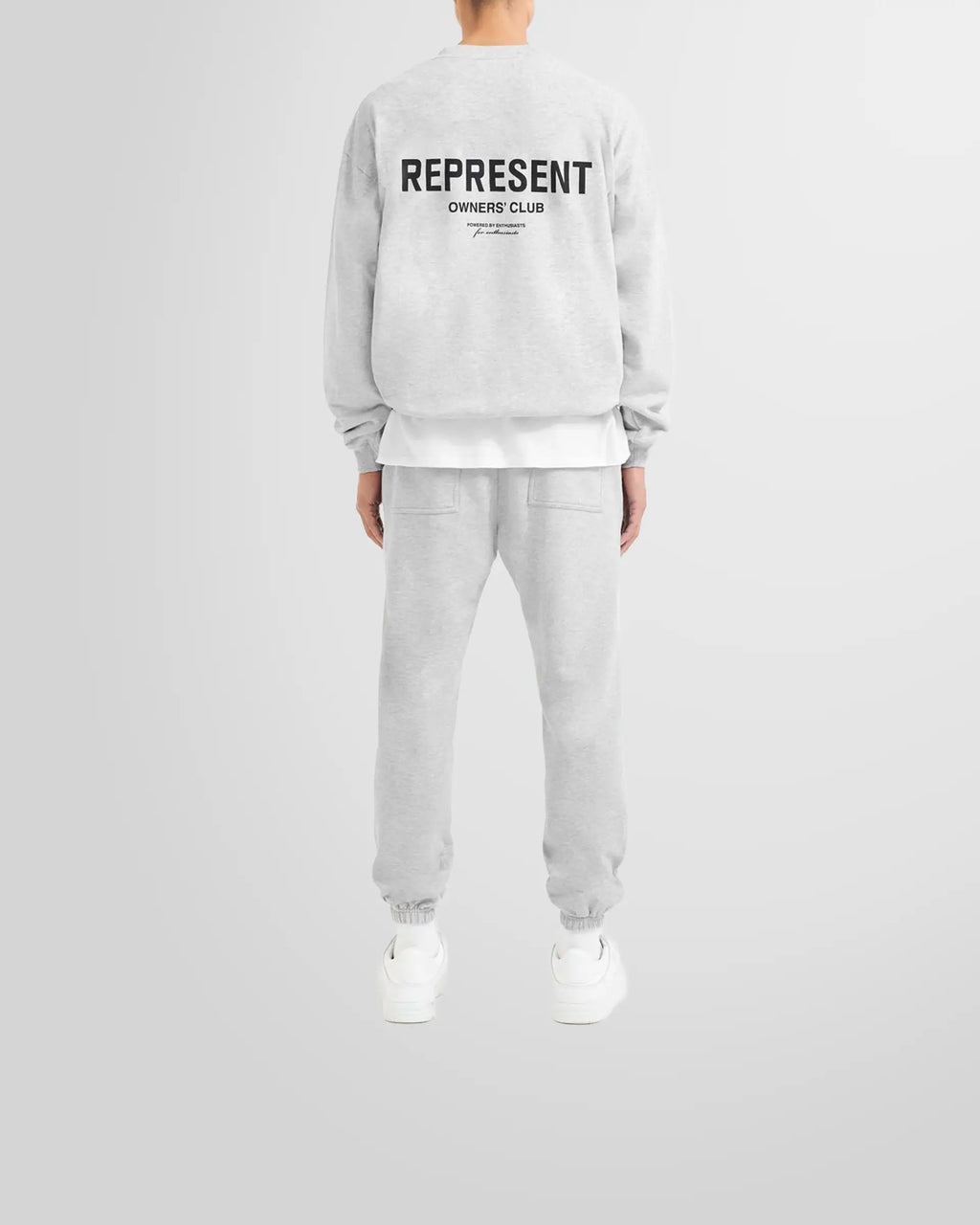 Model wearing the oversized Represent Owners' Club Sweater in ash grey.