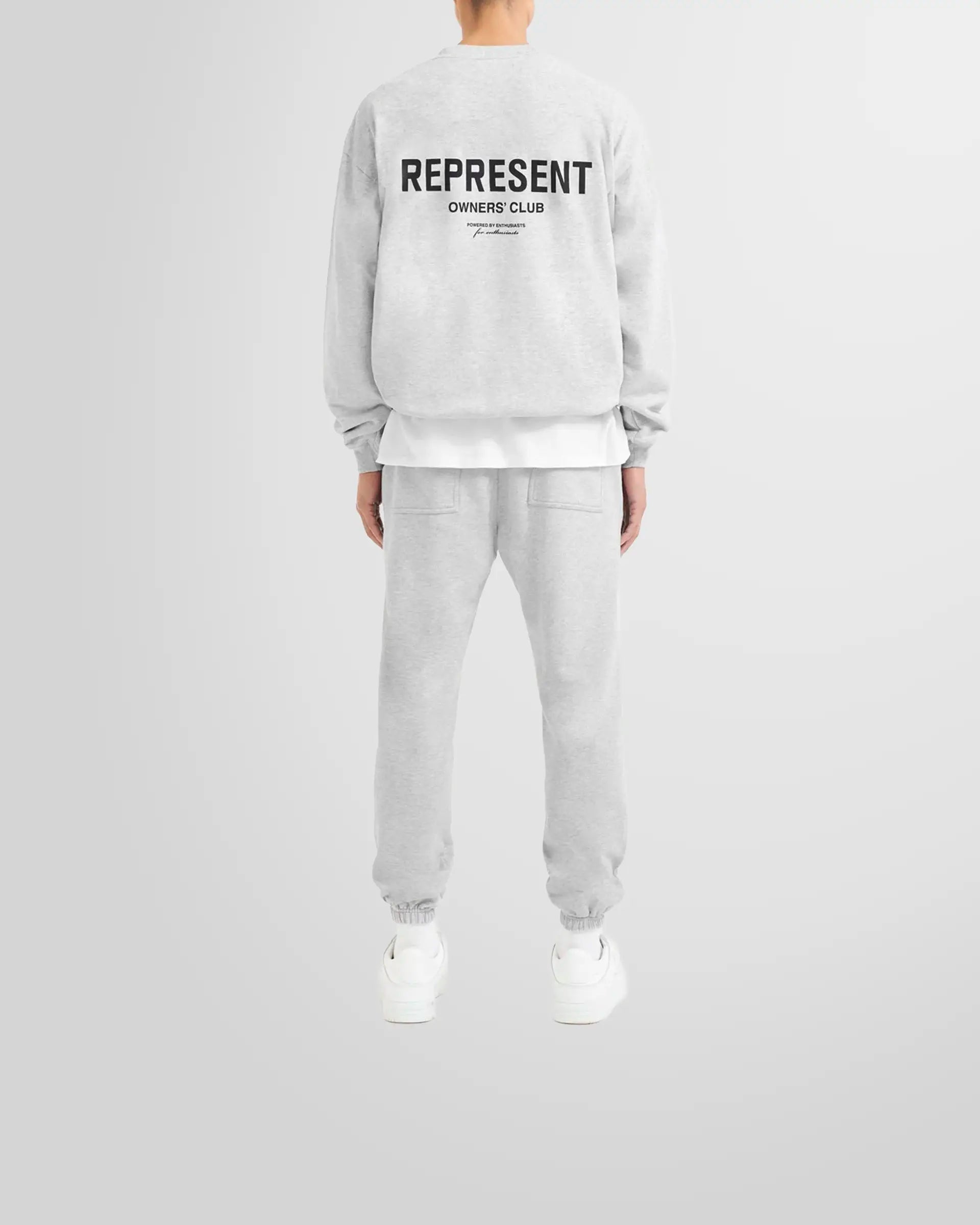Model wearing the oversized Represent Owners' Club Sweater in ash grey.