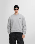 Front view of a model wearing the oversized Represent Owners' Club Sweater in ash grey showing the boxy fit.