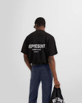 Model wearing the slightly oversized Represent Owners Club T-Shirt in black.