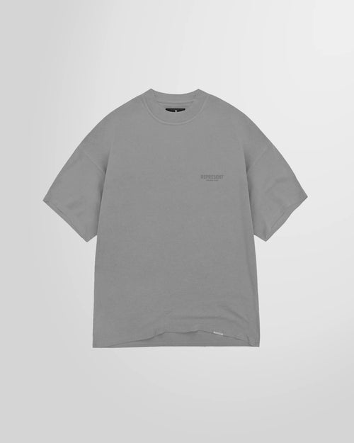 Front view of the Represent Owners Club T-Shirt in ultimate grey, showing the chest logo.