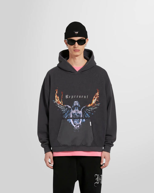 Model wearing the Represent Reversible Living Legacy Tour Hoodie in Sun Fade Grey, oversized boxy fit.