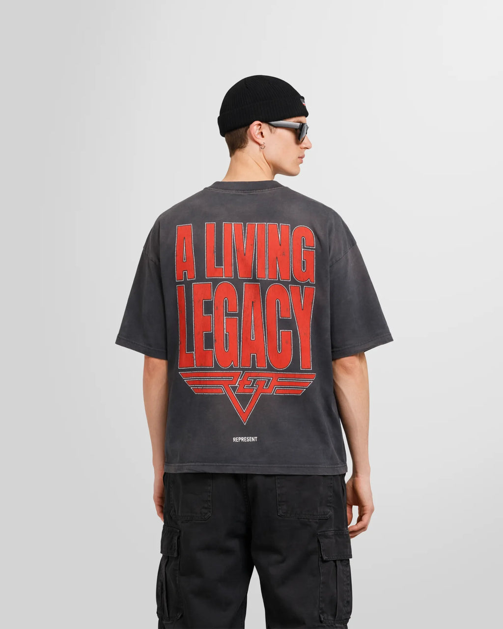 Back view of a model wearing the Sun Fade Grey reversible tee.