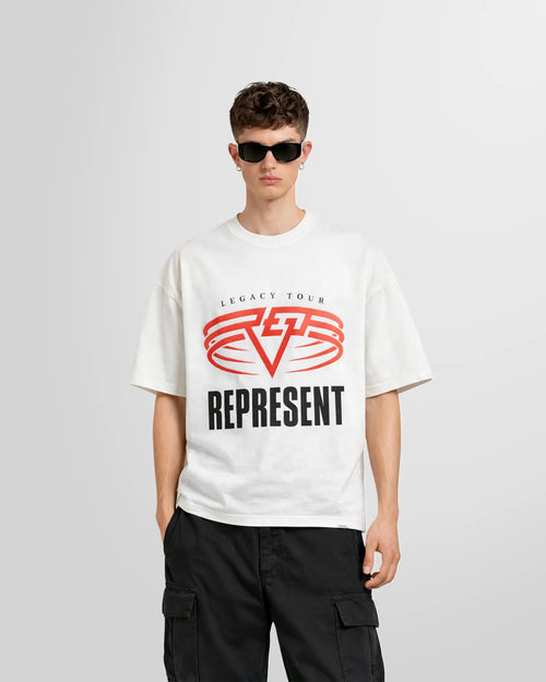 Front view of a model wearing the Represent Reversible Living Legacy Tour T‑Shirt in Flat White showing the oversized fit and the print in chest.