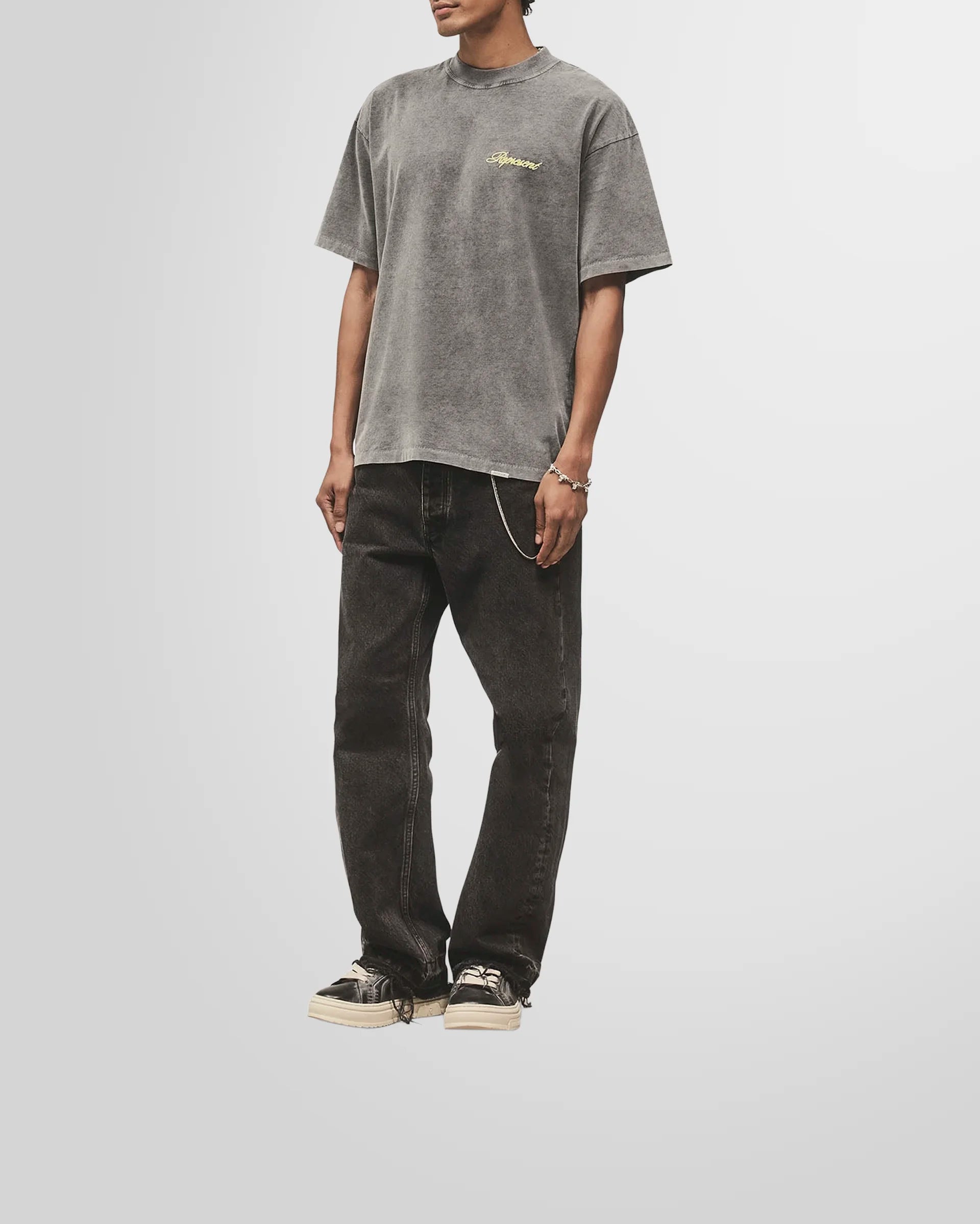 Model wearing the slightly oversized Represent Script Logo T-Shirt in vintage grey