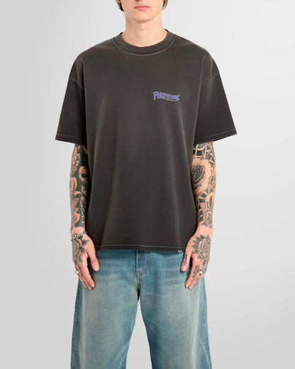 Model wearing the Represent Showcasing T‑Shirt in Stained Black with chest script logo.