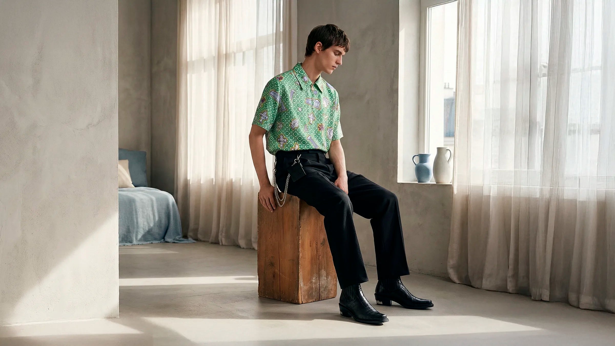 Model wearing shirt, wool trousers and boots from the collection Selected by HOMME+.
