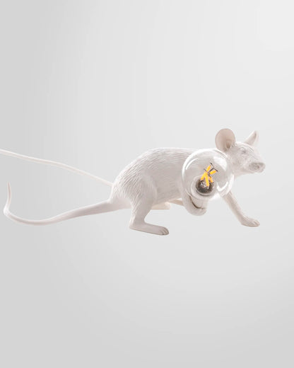 A close-up detail of the white resin Seletti Mouse Lamp, highlighting its realistic texture and the light bulb it holds.