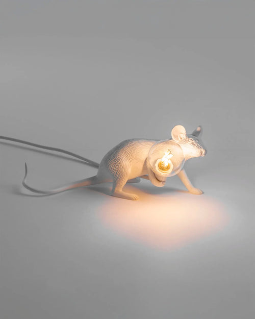 The Seletti Lie Down Mouse Lamp placed on a modern bookshelf, providing scale and showing how it complements home decor.